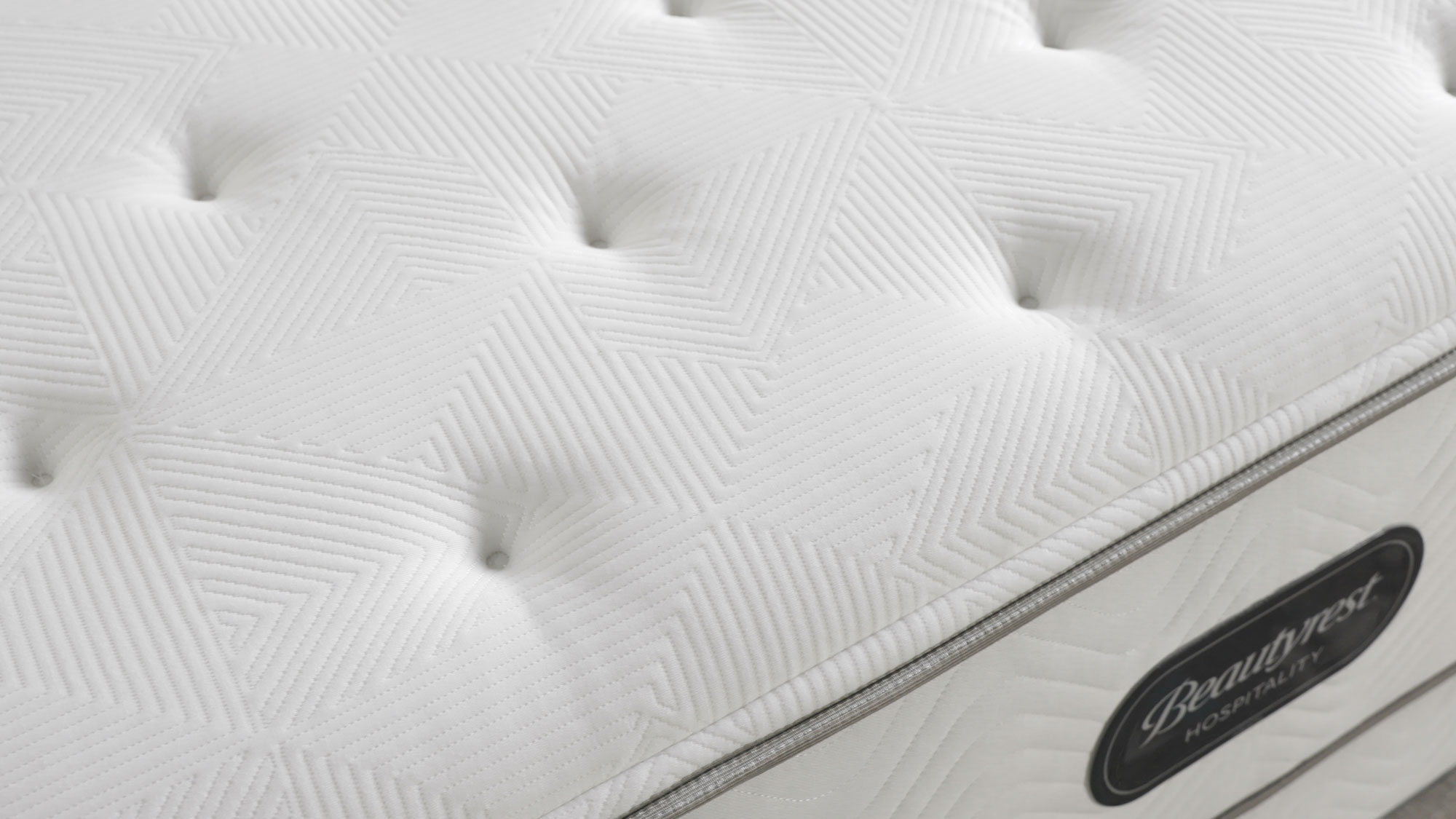 Quilted top panel and Beautyrest Hospitality label on a mattress
