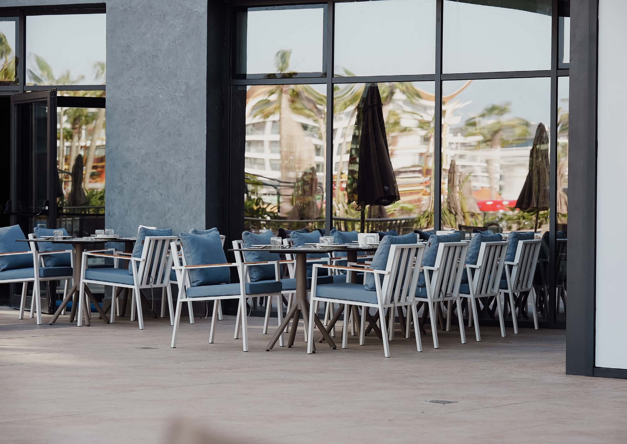 Icon outdoor dining chairs on a hotel terrace